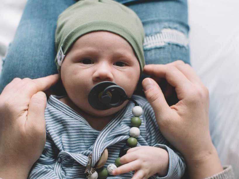 Photo of a baby boy in his mother’s lap.