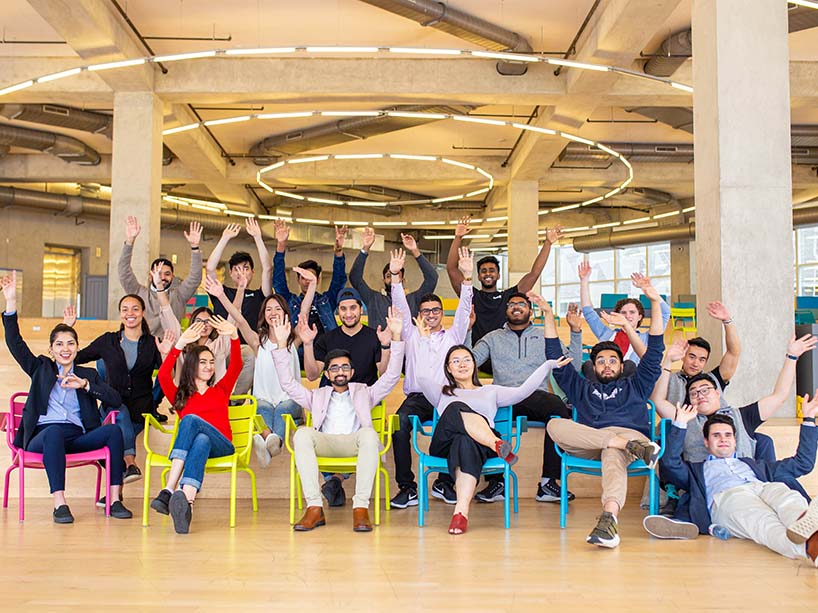 A Basecamp cohort sitting together pre-pandemic.