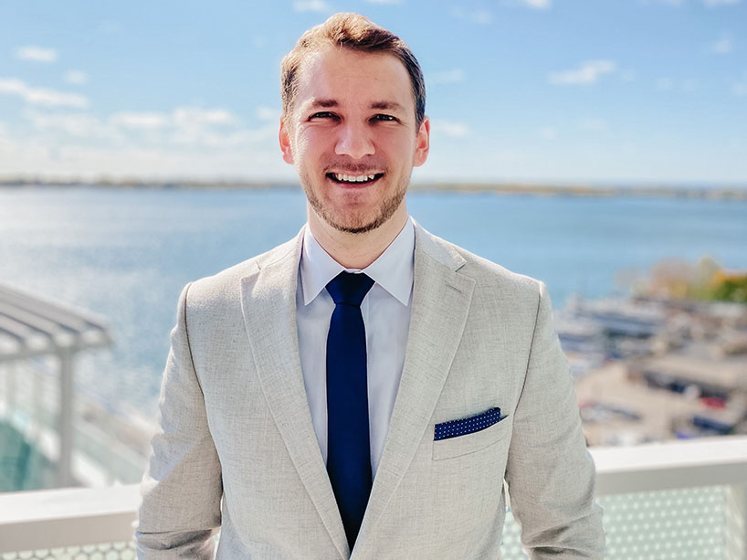 Nicholas Hill stands in front of Lake Ontario.