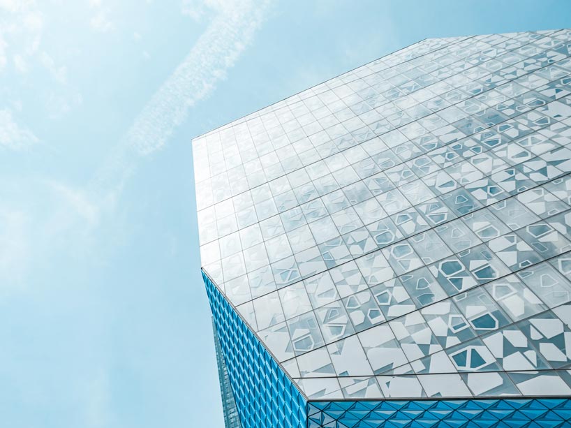 The SLC building on the university's campus against the sky.