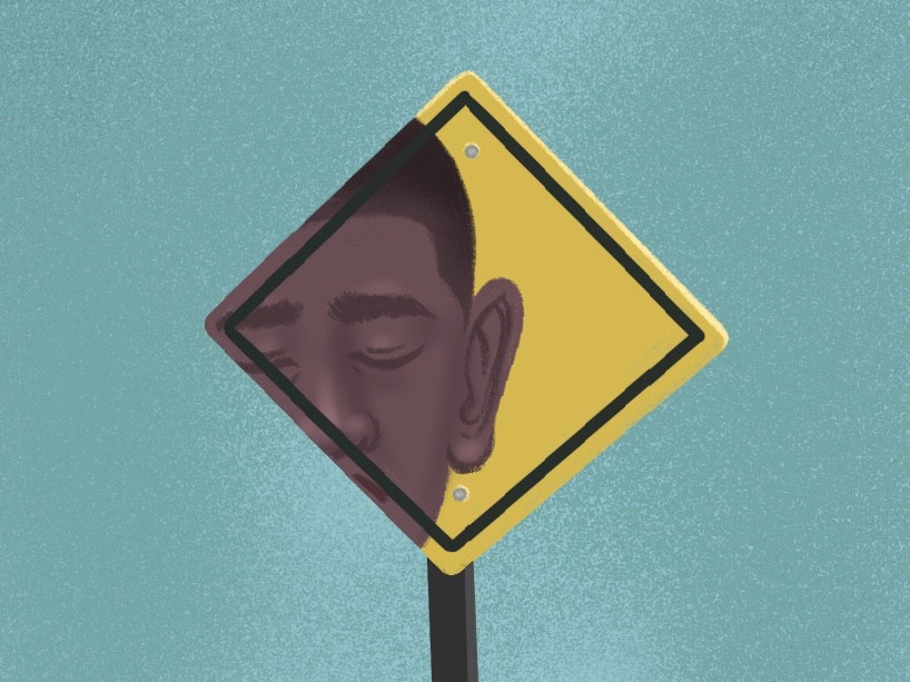 Face of a Black man with closed eyes on a yellow road sign.