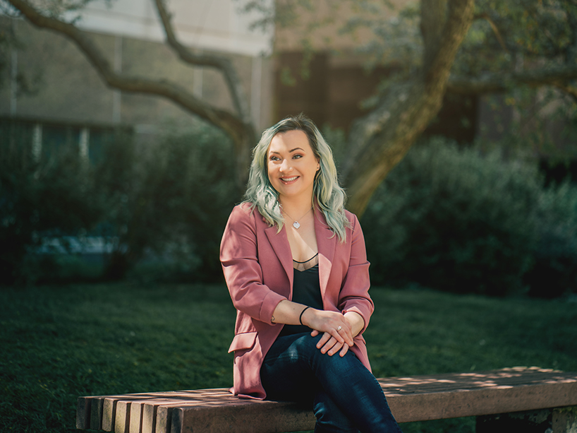 Erin Meger sitting on a bench outside.
