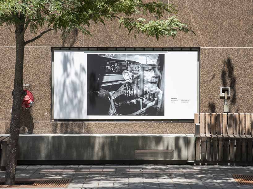 Chris Donovan’s photo of a boy in a window displayed on campus. 