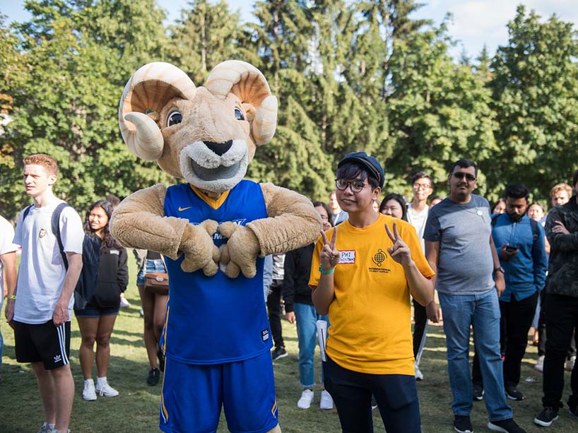 Ryerson mascot Eggy the Ram with a crowd of students