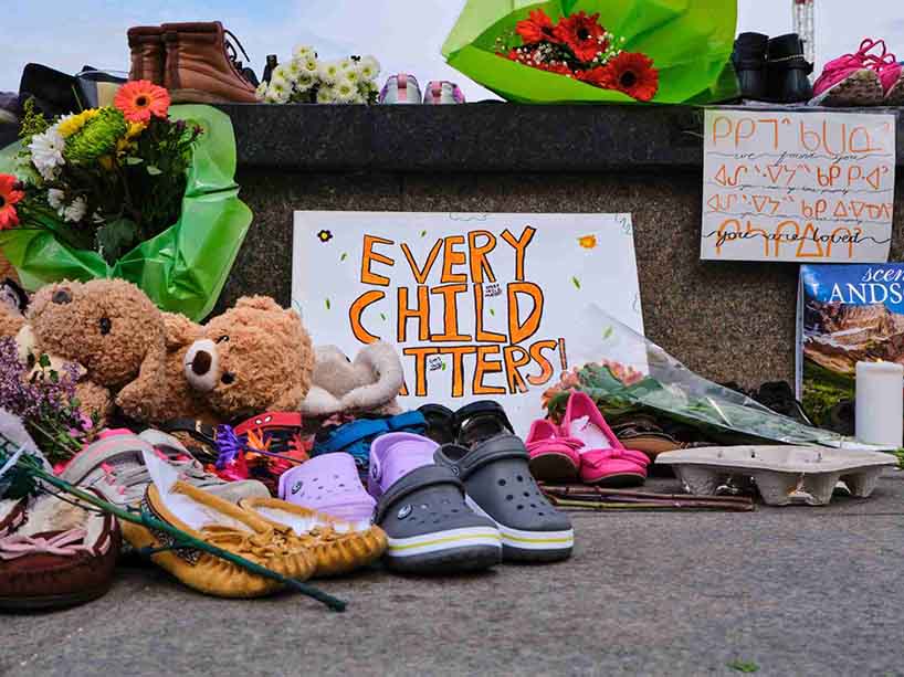 A memorial in recognition of the children who died at the residential schools with a sign that says Every Child Matters.