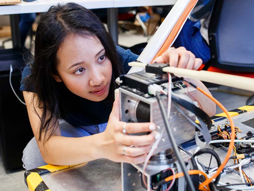 Student works with robot in Centre for Urban Innovation