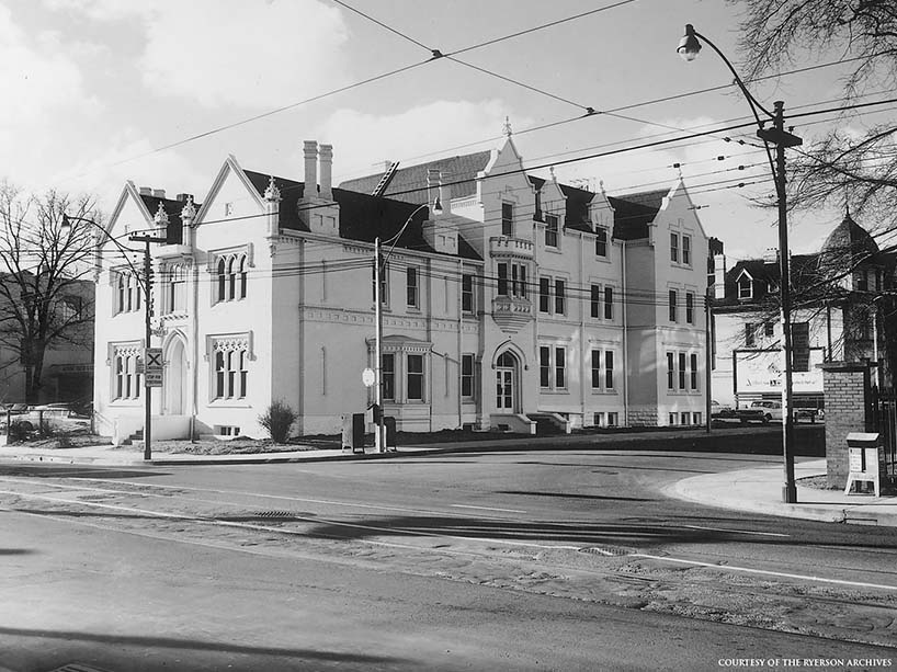 Black and white side-angle photo of Oakham House taken from across the street.