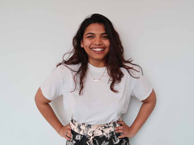 Kanan Shah is standing, looking at the camera with a big smile