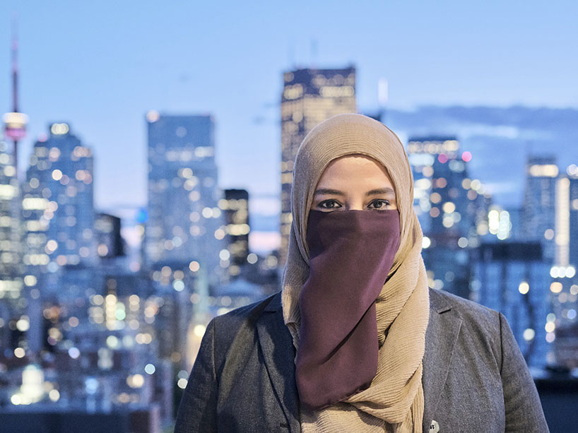 Sakeena Mihar, CEO and co-founder of Savyn, facing the camera with the Toronto skyline in the background at night.