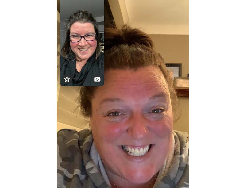 a screenshot of a video call between classmates Amanda McBain, top left, and Sandra Leach, centre, both smiling.