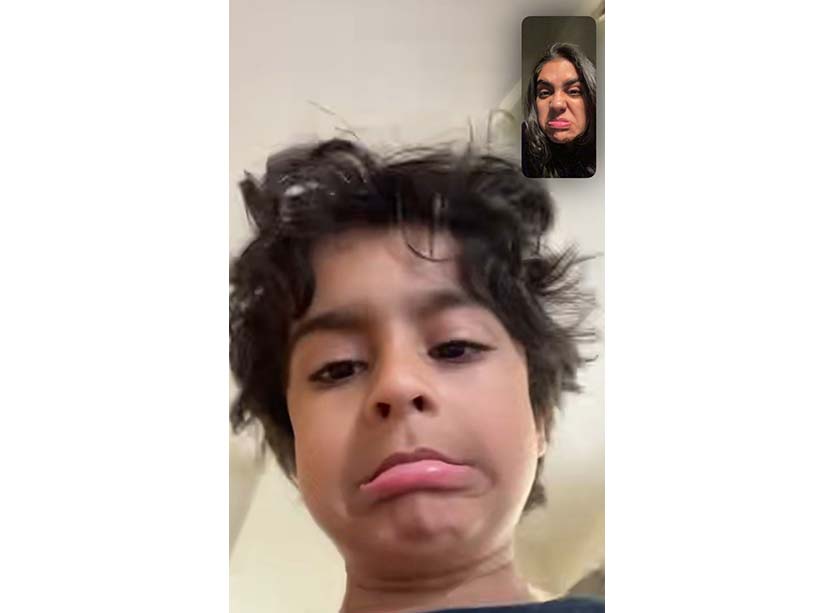 a screen shot of a video call between student Reva Chaudhary, top right, and her little brother, bottom centre, making funny faces at each other.