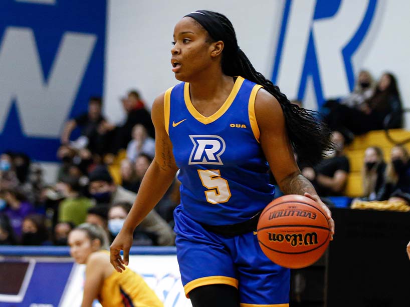 Kyia Giles dribbles a basketball