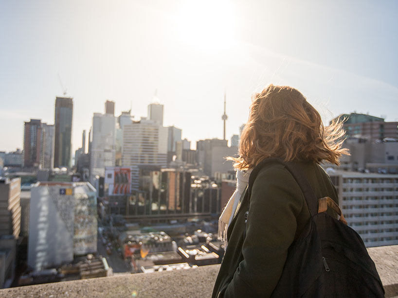A woman looks over the city skyline.