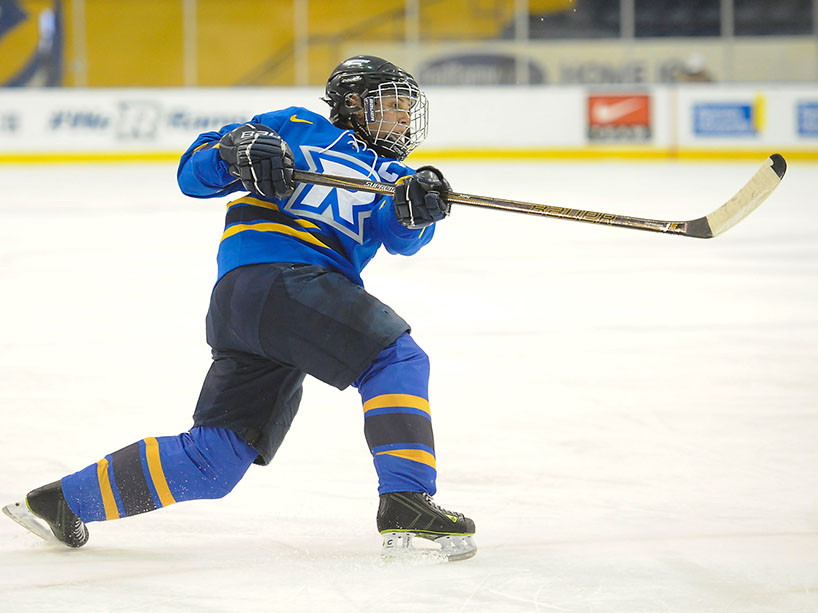 A female hockey player on the ice.