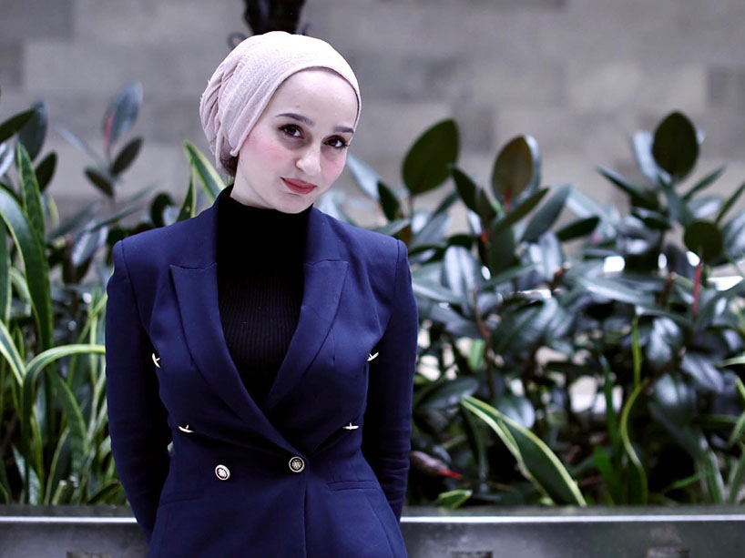 Hanen Nanaa standing outside.