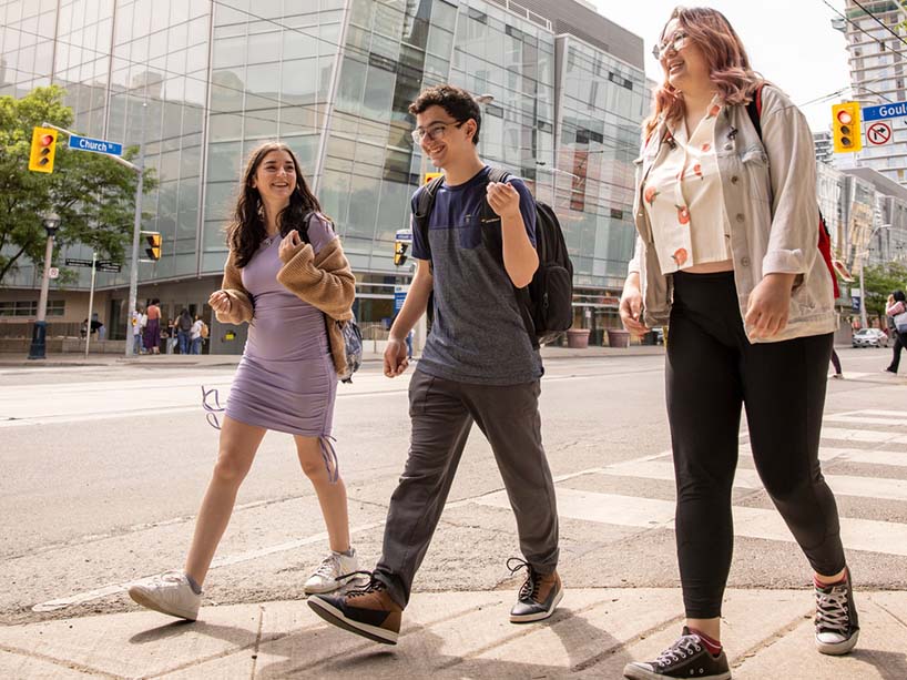 Three students at the intersection of Church Street and Gould Street. 