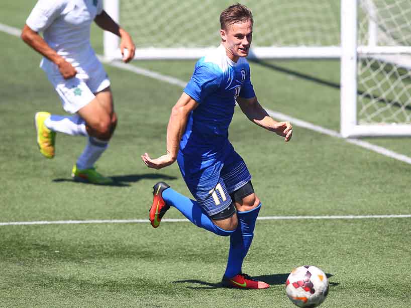 Young man playing outdoor soccer.