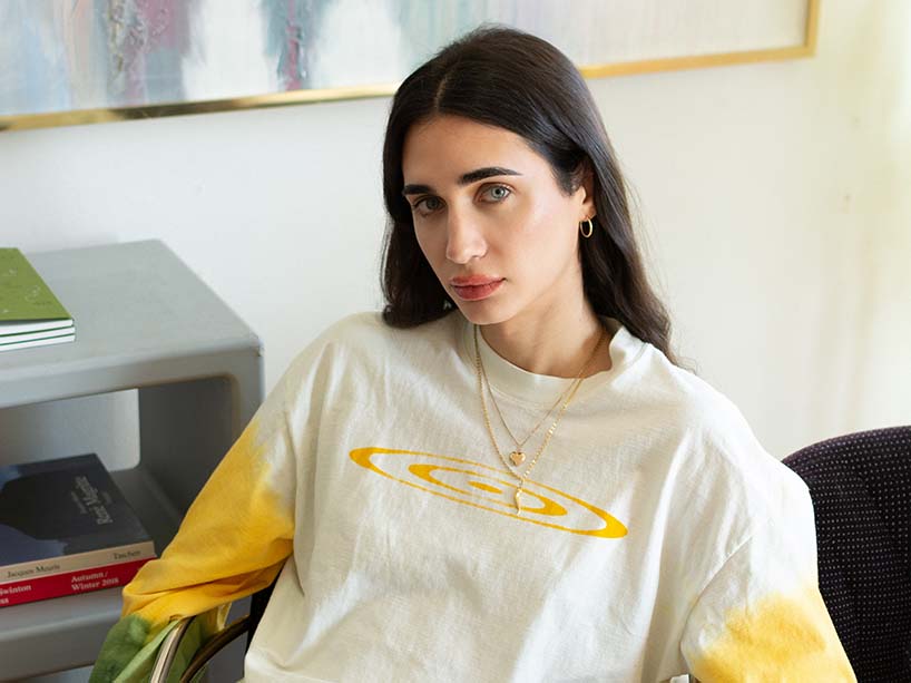 Luis De Filippis sitting in a chair looking at the camera.