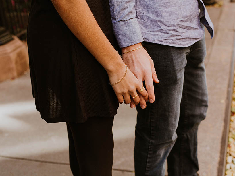 A woman's hand holding a man’s hand