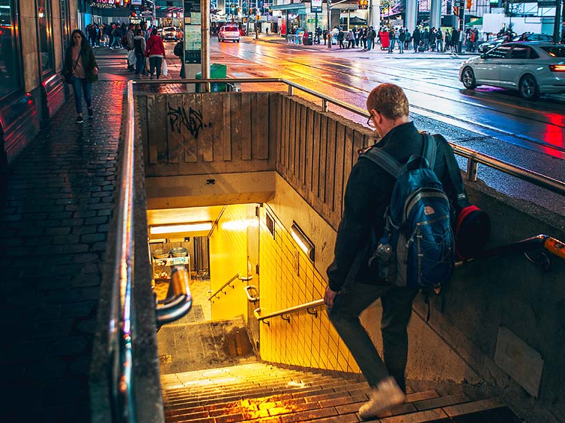 A student walks down the steps to Dundas subway station at Yonge and Dundas Square