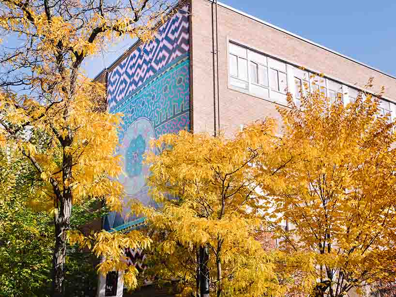 Colourful mural hangs on building wall