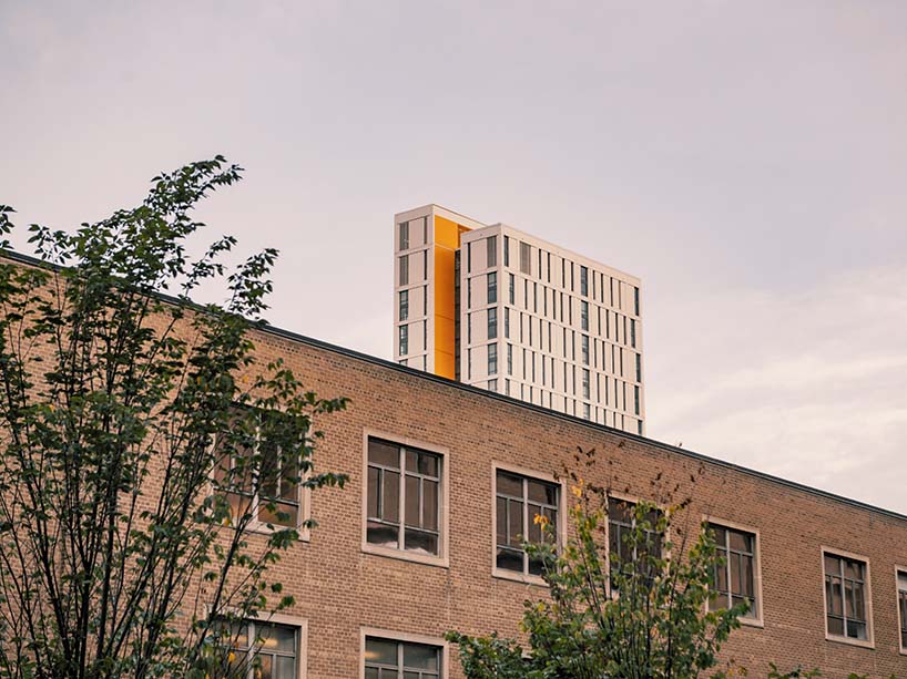 The top of Daphne Cockwell building seen above campus building.