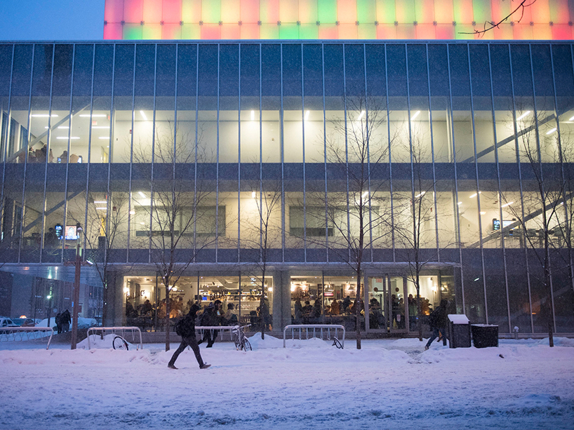A student walking through a snowy campus.