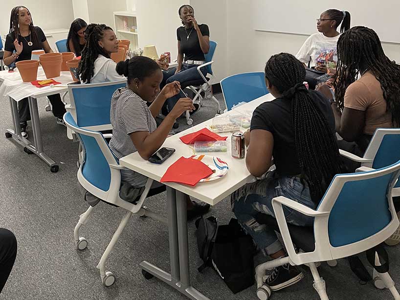 Black TMU students gathered around a table.