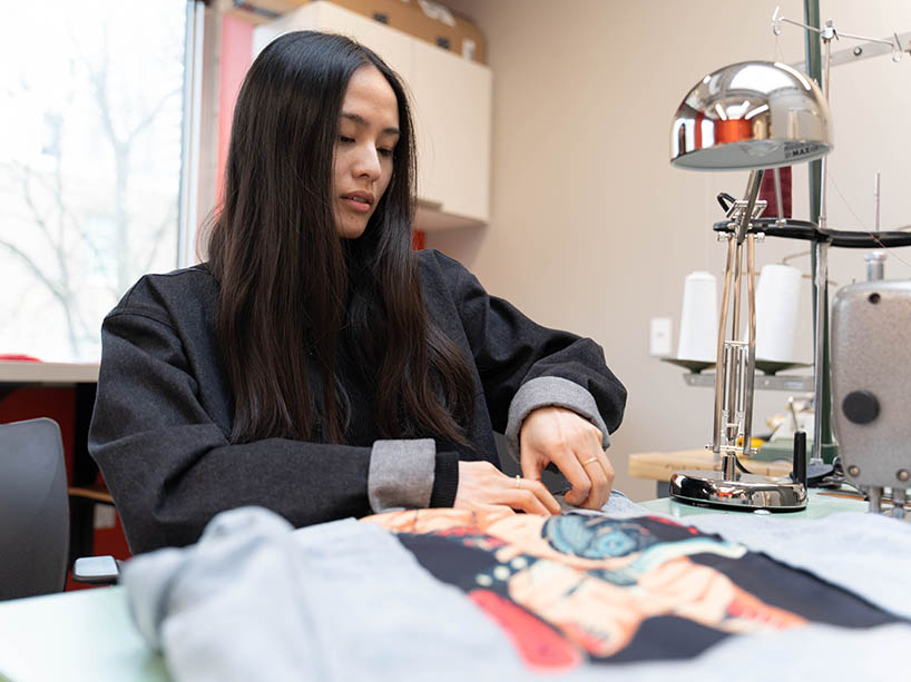  Jane Souralaysack working on a jacket.