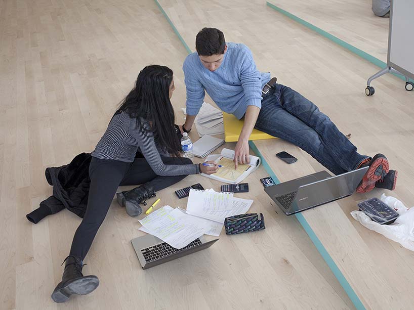 Students working together on the floor.
