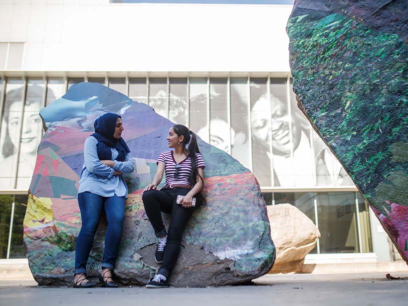 Two students talking on campus.