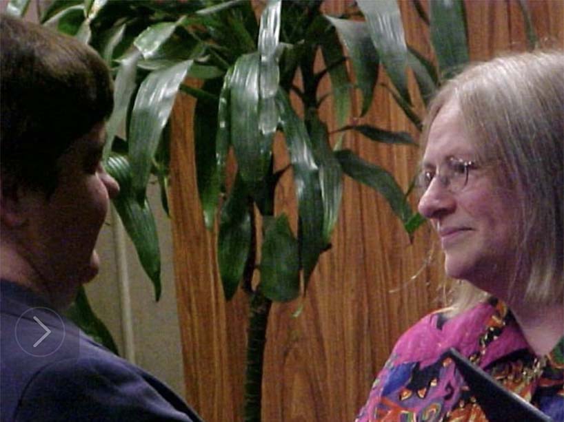 Two women looking towards each other.