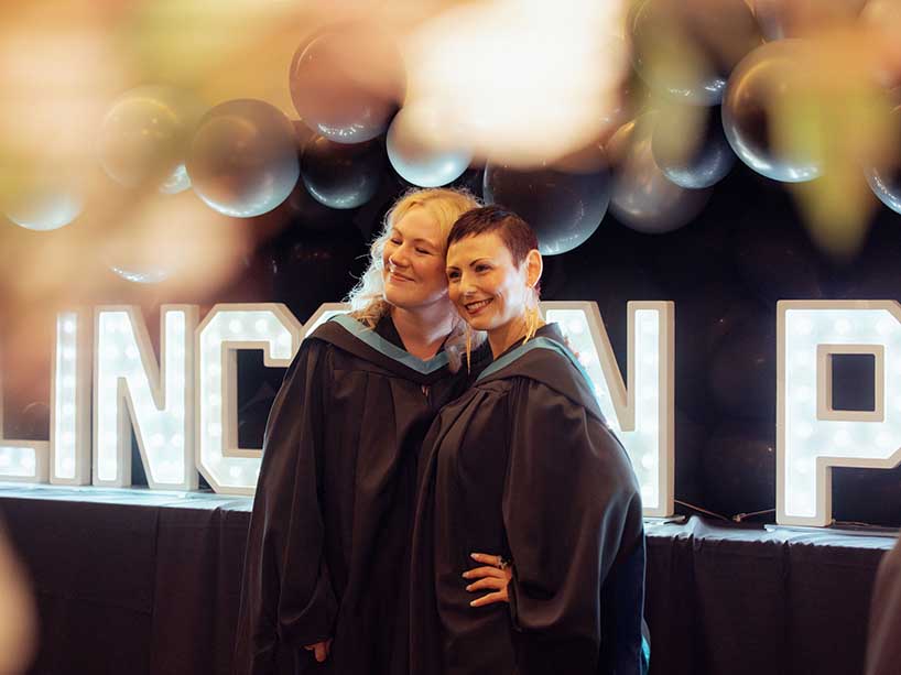 Karlena Koot and Oksana Romanov in front of a “Lincoln Proud” marquee.  Photo credit: Kenya-Jade Pinto.