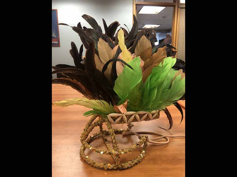 A feathered headpiece sitting on a table.