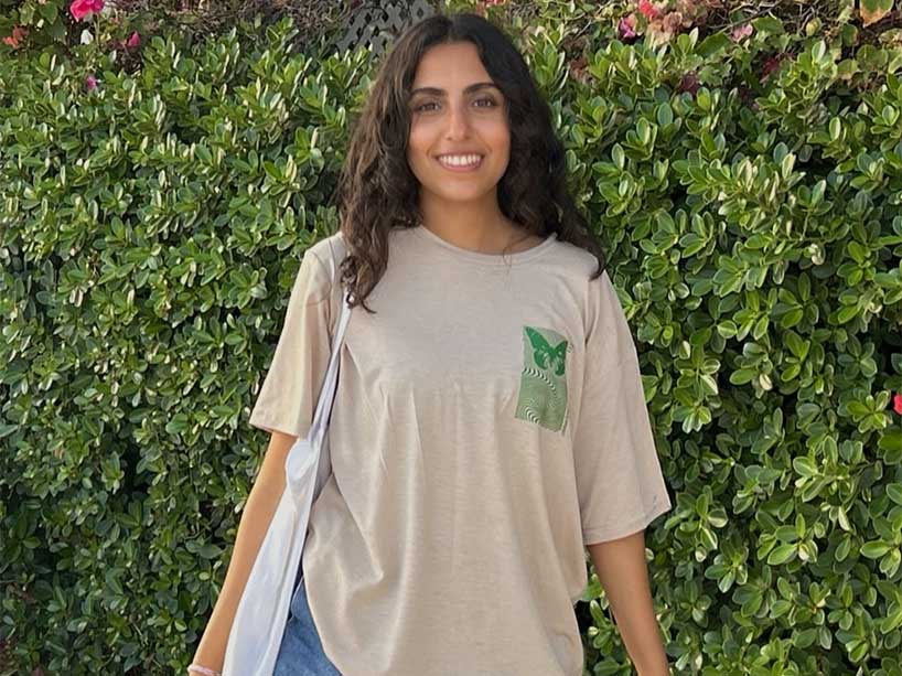 Sonali Chatrani against a green, leafy background. 