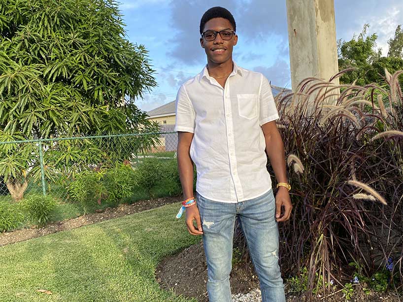 Nathan Eristhee in a white dress shirt and glasses.