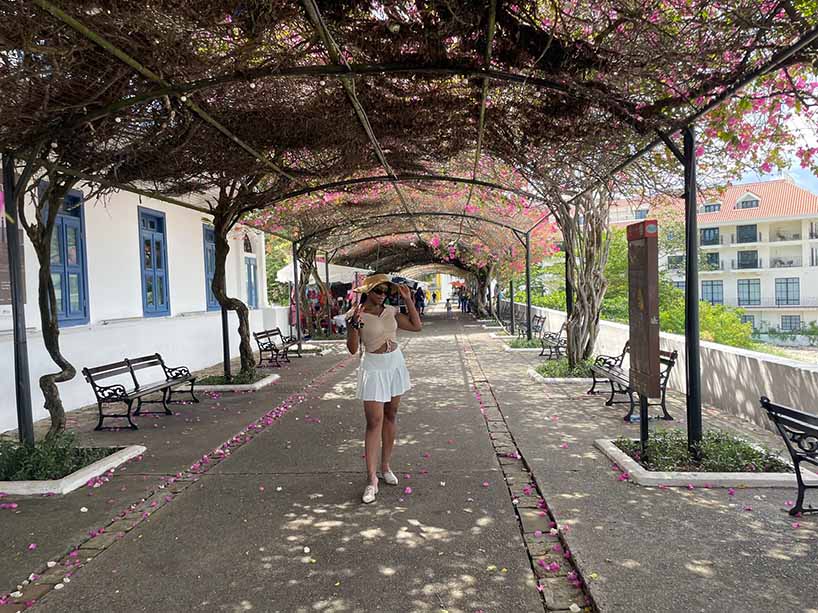 Adriana Hyde under a vine covered overpass.