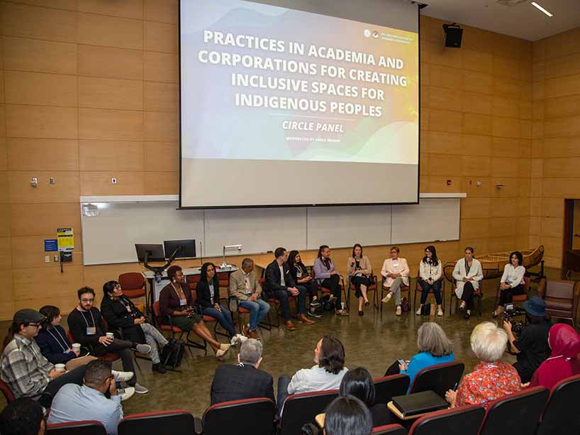 Community members sit in a large circle at the Reconciliation in Business Conference