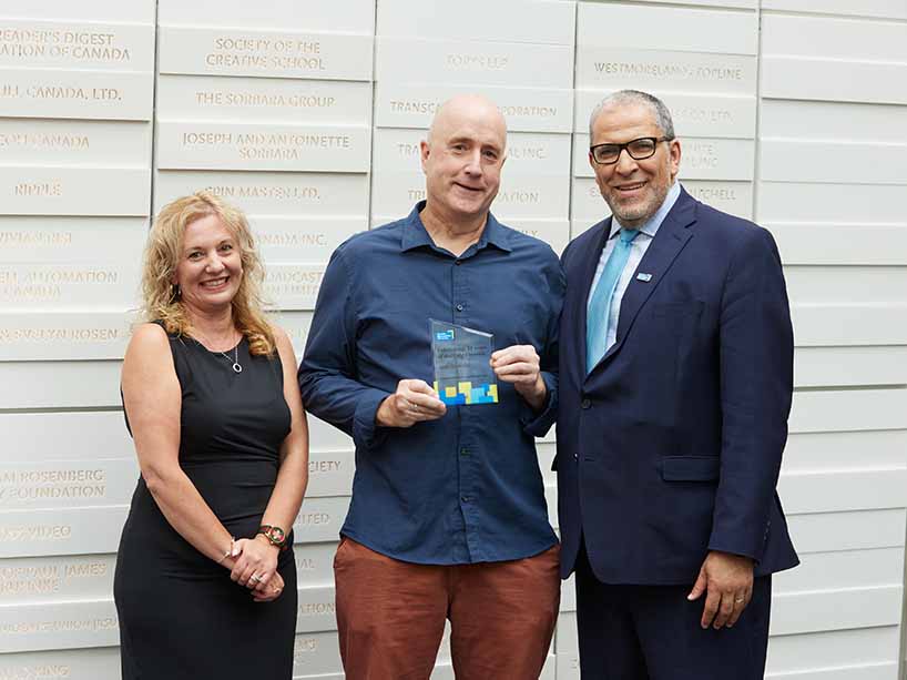 Arne Kislenko, centre, with his long service award, Roberta Iannacito-Provenzano, provost and vice-president, academic, at left, and President Mohamed Lachemi on the right.