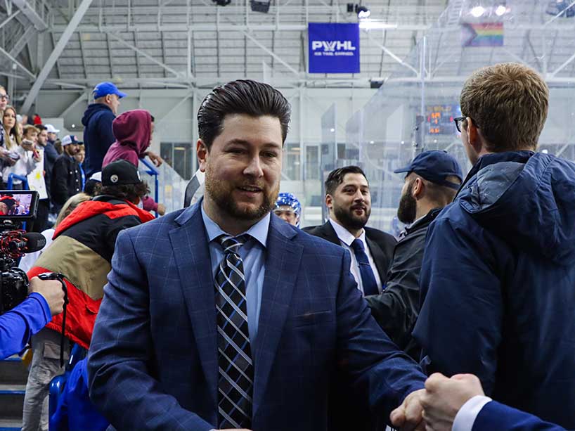 TMU Bold men’s hockey coach Johnny Duco fist bumps a fan after the team’s double overtime win on Thursday, March 14.