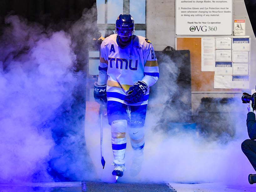  TMU’s Kyle Bollers steps on to the ice surrounded by smoke as part of the opening introductions. 