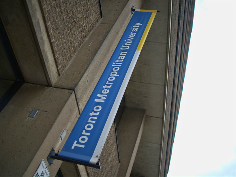 A university banner on the side of a building.