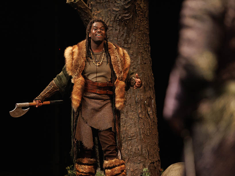 A young man in costume on stage. 