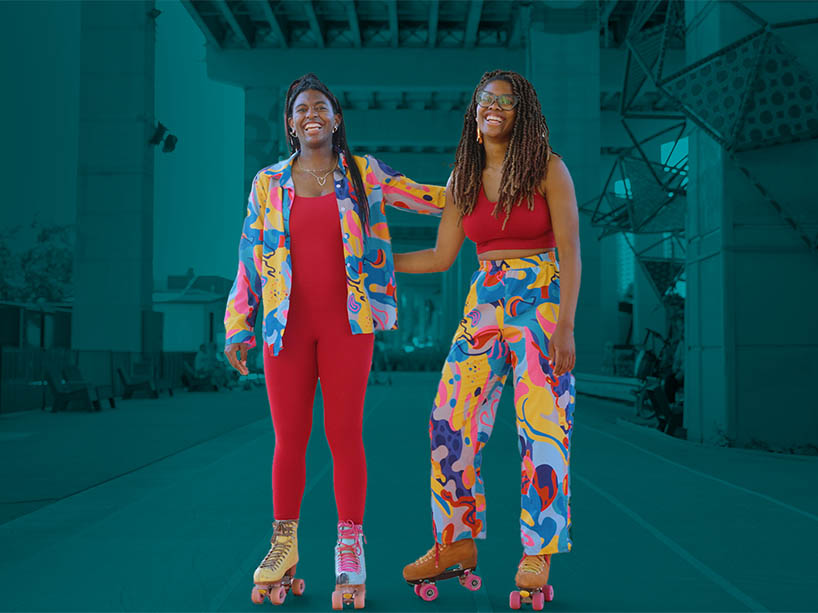 The Hines sisters, Sonnet and Geneva, with their arms around each other on a roller skating path.