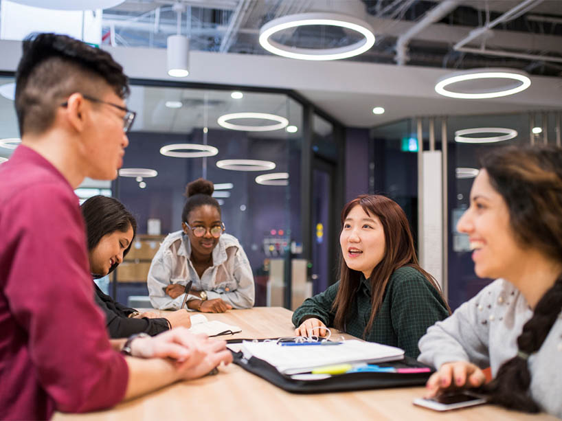 A group of students in a study group at the library.
