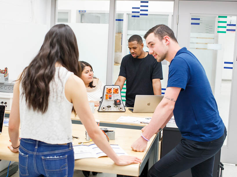 Four people working on a project about clean energy.