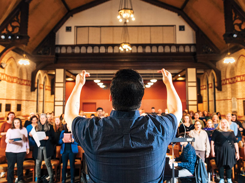  A choir leader conducting a choir.