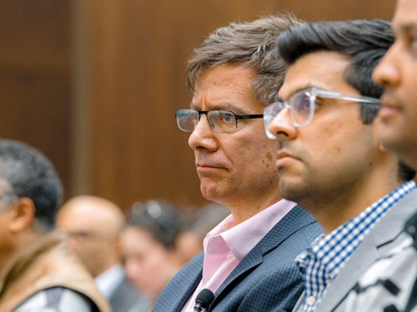 John Beebe sits in an audience.