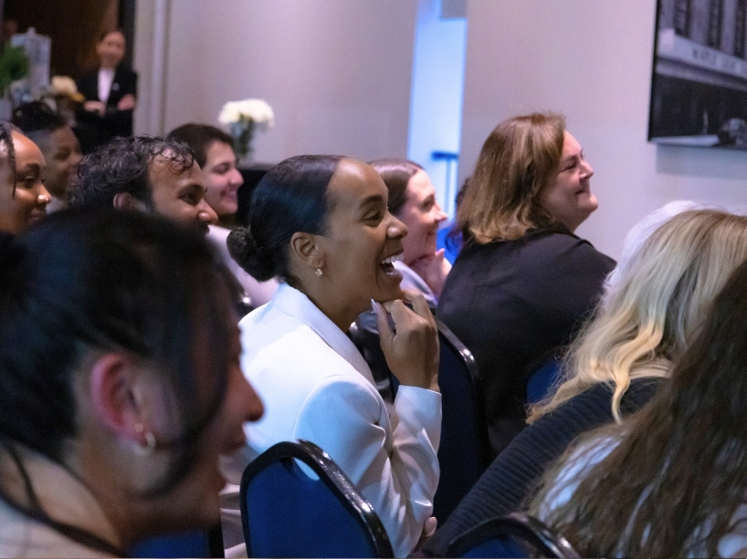 Seated guests smiling during the Bold Women Giving Collective launch.