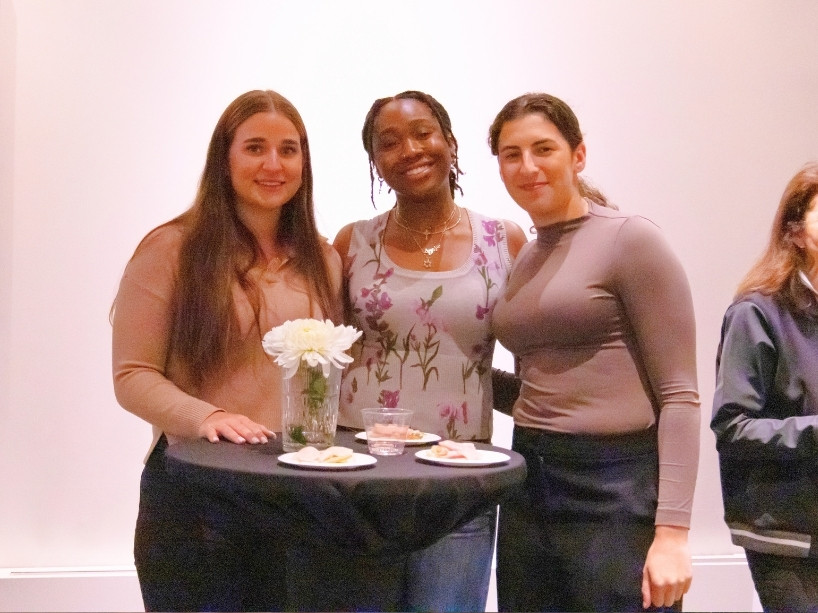 Three guests smiling and posed at table during the Bold Women Giving Collective launch.